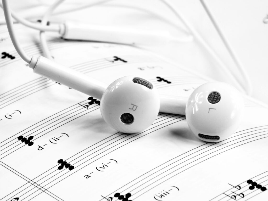 Sleek White Earphones on Musical Notes - 4K Wallpaper Background