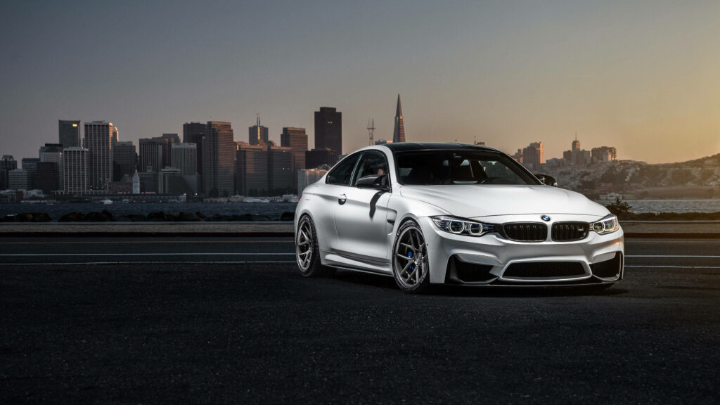 Urban Elegance: 4K Snapshot of a White BMW in Cityscape Backdrop Wallpaper