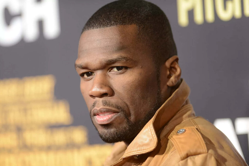 50 Cent in brown leather jacket with intense gaze embodying iconic rapper power wallpaper
