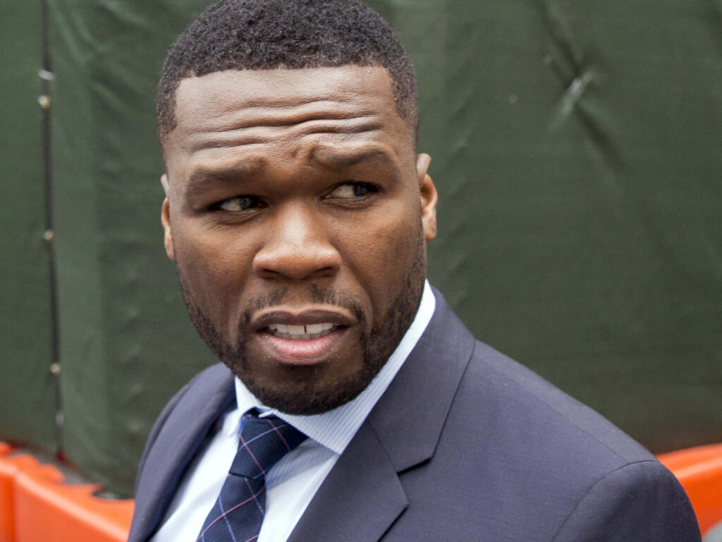 50 Cent in sharp suit and tie exuding confidence before first live show iconic rapper wallpaper