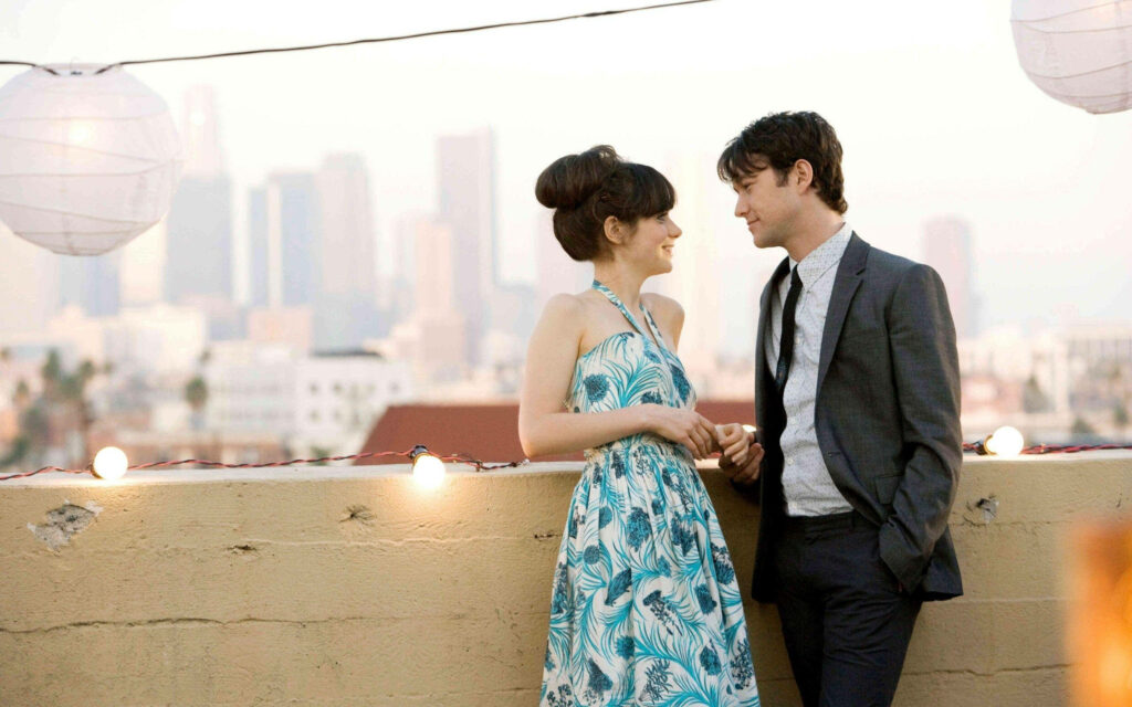 Romantic rooftop scene from 500 Days of Summer with city lights and glowing lanterns background Wallpaper