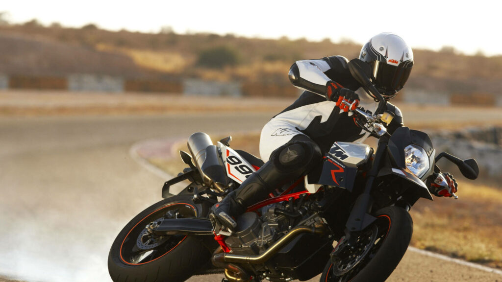 Thrilling Stunts on KTM: 4K Wallpaper of a Bike Rider Performing on the Track