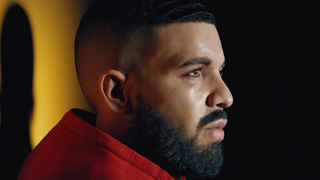 Soft and Fiery: Drake's Red Hoodie Side Profile Wallpaper