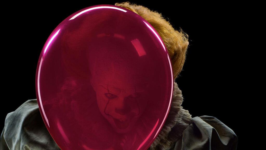 Clowning Around: Pennywise with His Red Balloon in this IT Wallpaper