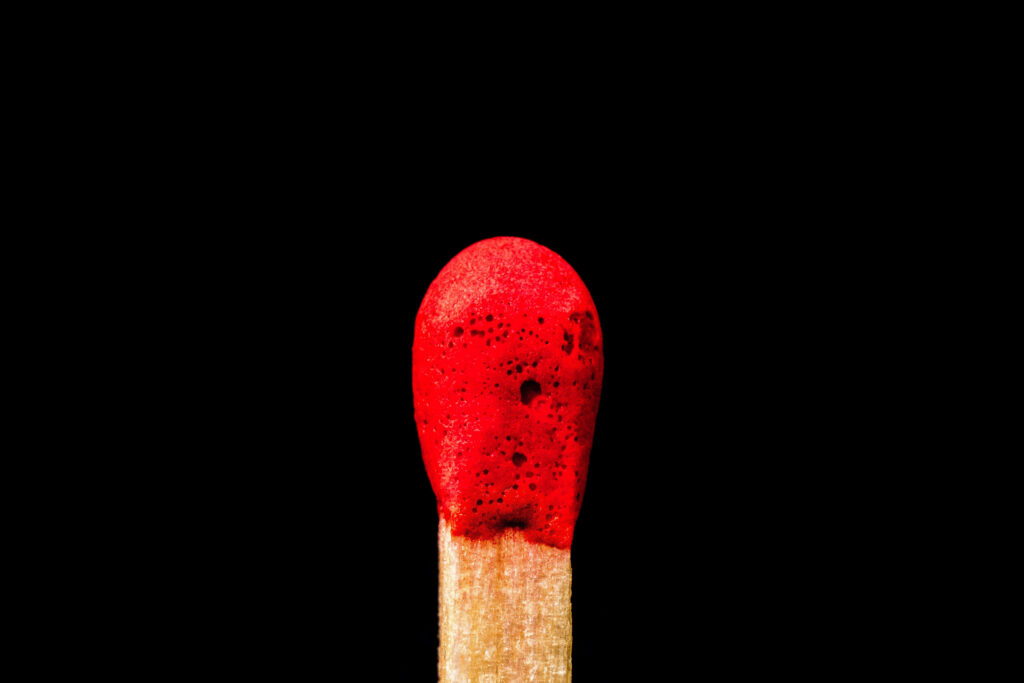 Matchstick: Intense Contrast in a Fiery 4K Close-up Wallpaper