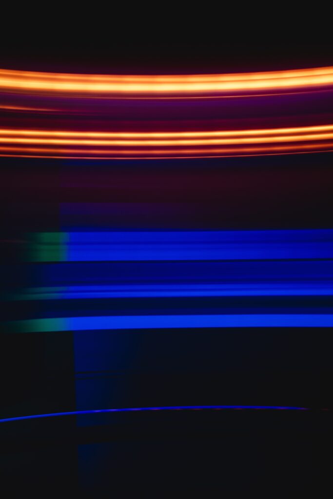 Vibrant Abstract Wallpaper: Glowing Blue & Orange Lines on Dark Background