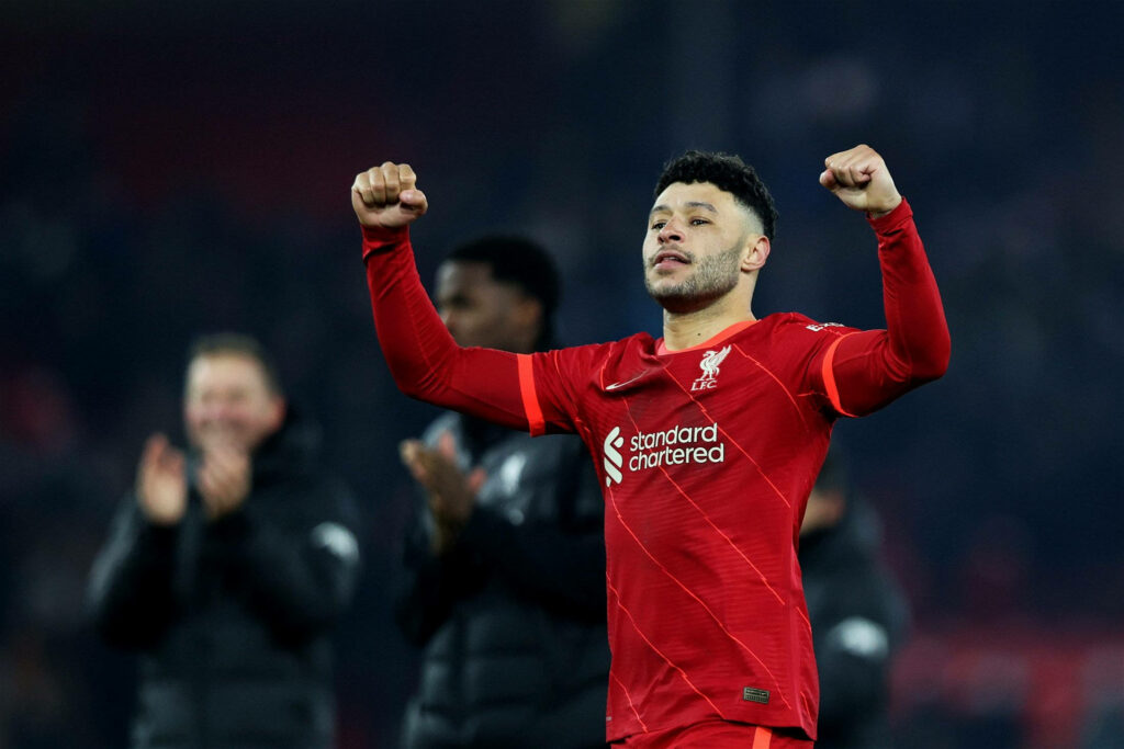 Alex Oxlade-Chamberlain Liverpool player celebrating victory flexing arms on football field wallpaper