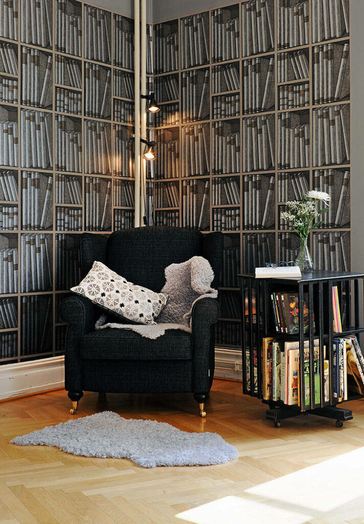 Enchanting Composition: Captivating Bookshelf ambiance enhances the Black Chair's allure Wallpaper