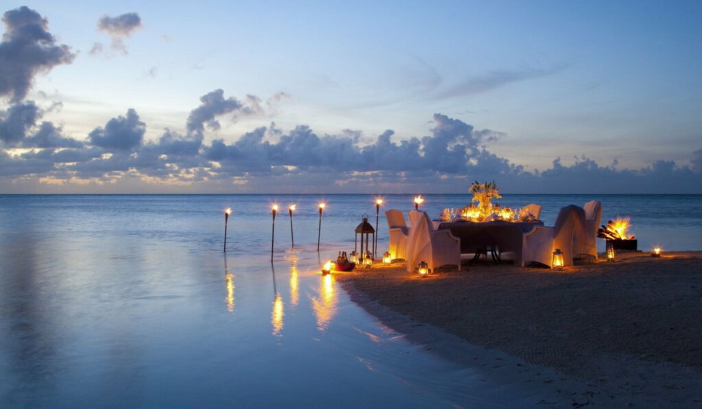 Romantic Ocean Sunset: A Enchanting Evening Dinner with Candlelit Romance on the Beach Wallpaper