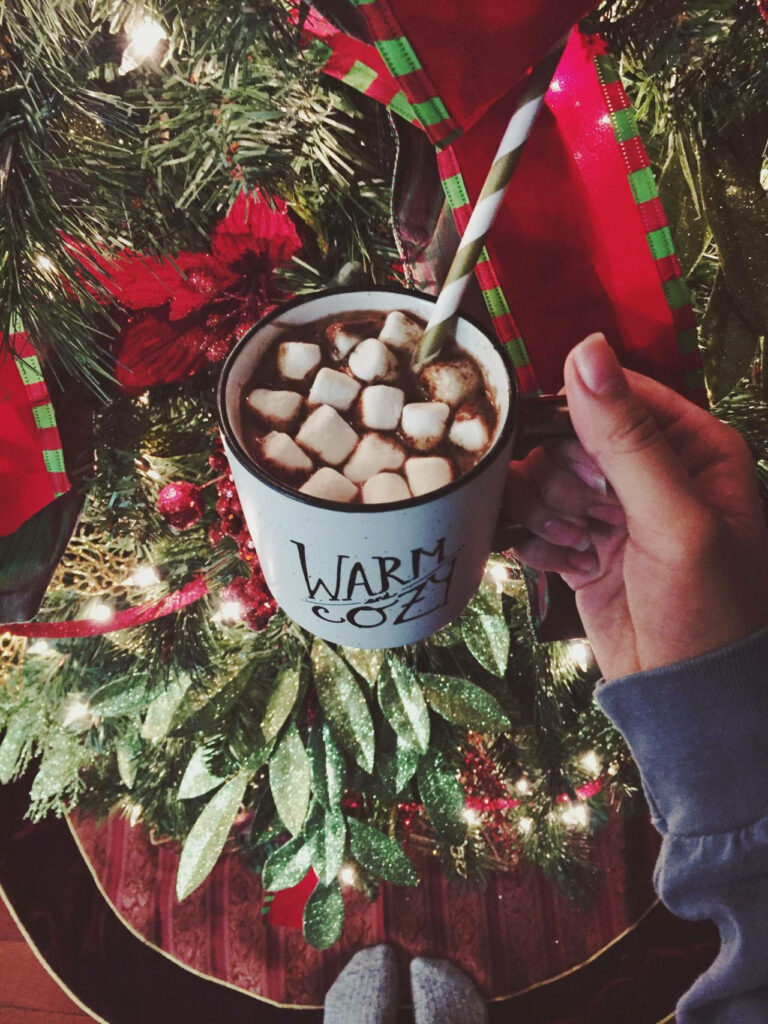 Cozy Christmas Delight: Savoring Hot Chocolate Amidst Festive Wonderland Wallpaper