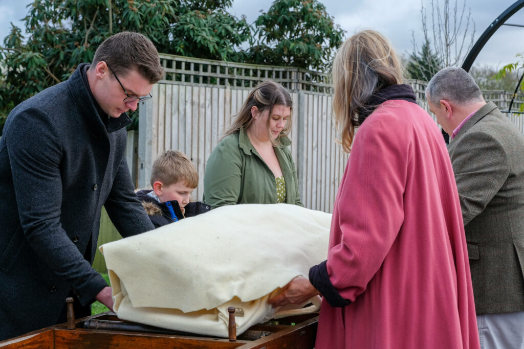 Serene Farewell: Capturing the Intimate Moments of a Family's Outdoor Funeral Preparations Wallpaper