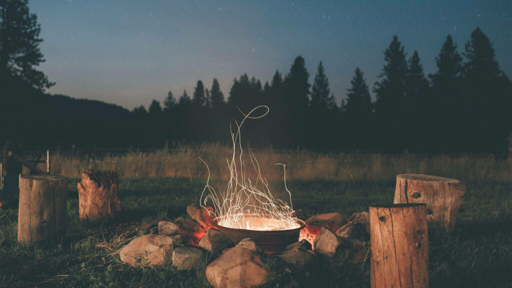 Cozy Camping Ambience: A Dusk Filled with Firelight Wallpaper