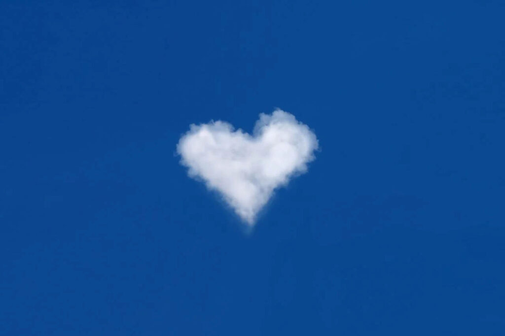 Serene Sky with a Fluffy Heart-shaped Cloud Wallpaper