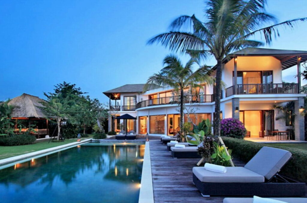 Exquisite Dreamscape: A Captivating Luxury House with Illuminated Pool under Starlit Ambience Wallpaper