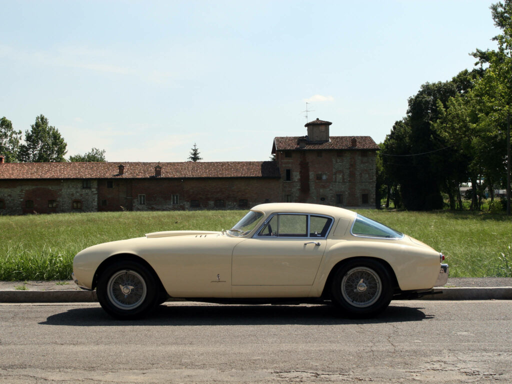 Sleek and Opulent: 4k Cream Ferrari 375 MM Racing Car Model Shines on the Roadside Wallpaper