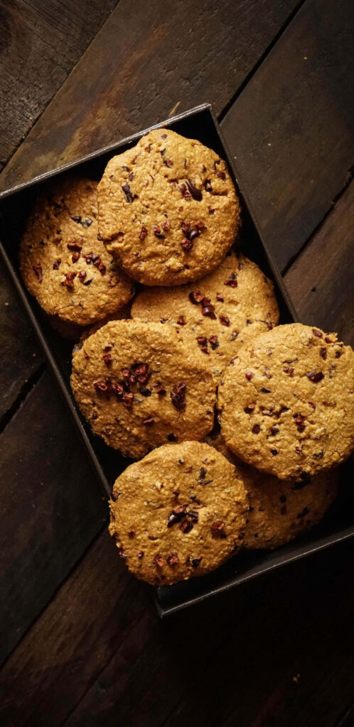 Country Comfort: Scrumptious Chocolate Chip Cookies on a Cozy Wood Table Wallpaper