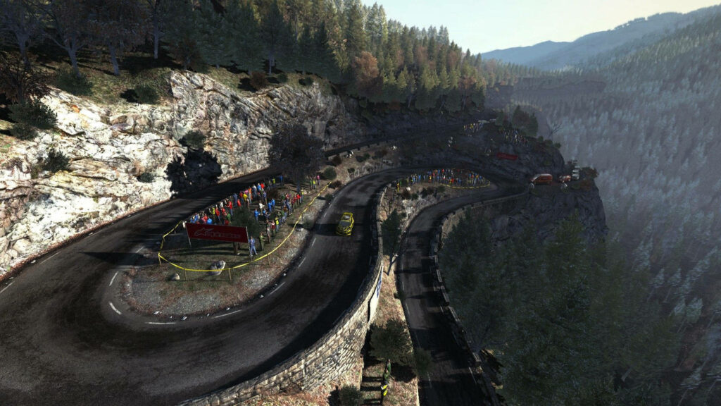 Thrilling Mountain Rally Circuit Surrounded by Lush Pine-Filled Wilderness: A Captivating View from Above Wallpaper