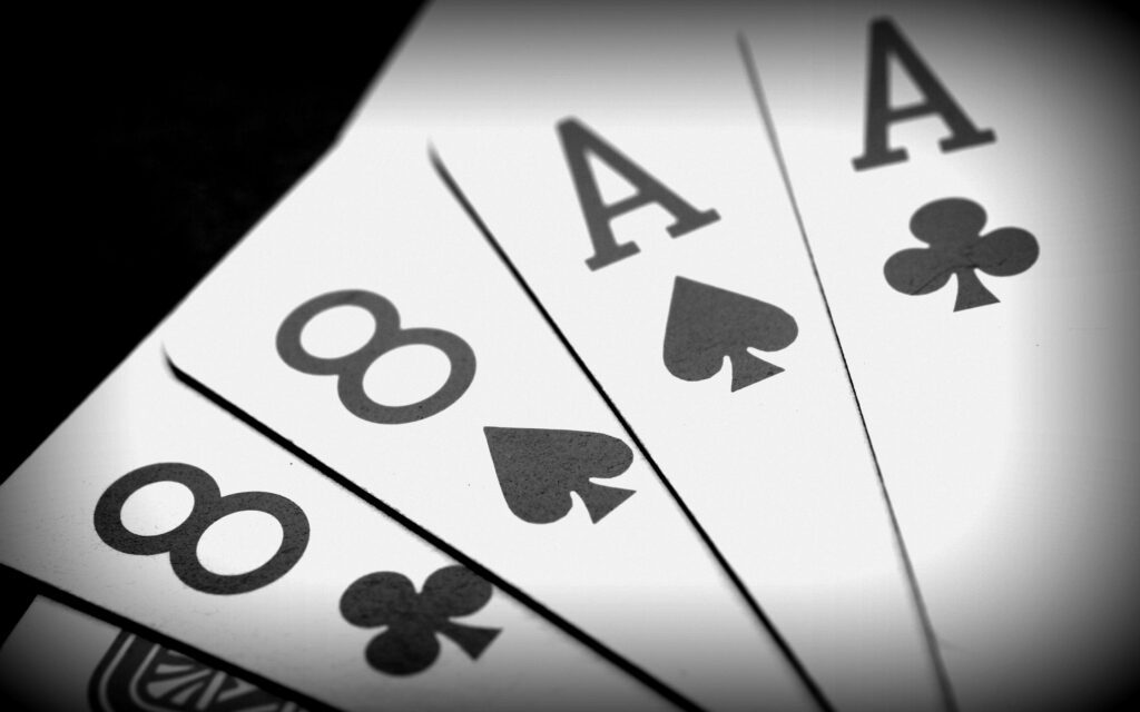 Winning Combination: Black Aces and Black Eights in a Poker Game Wallpaper