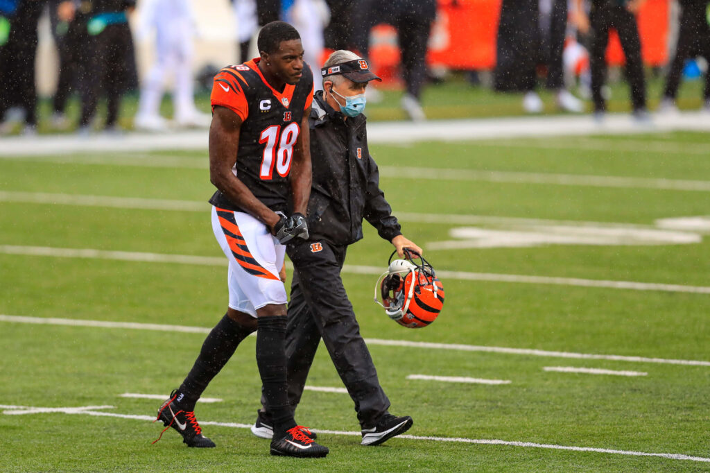 A.J. Green walking off the field with assistance showing football injury during game wallpaper