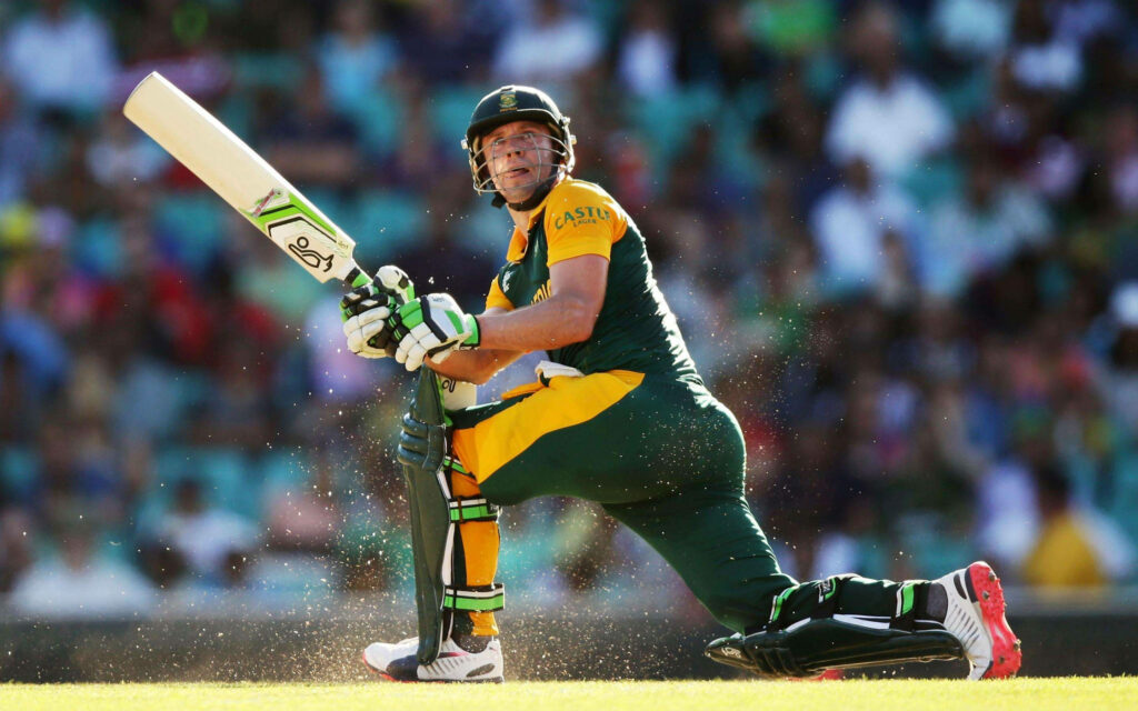 AB de Villiers crouching with bat in cricket match intense focus athleticism wallpaper background