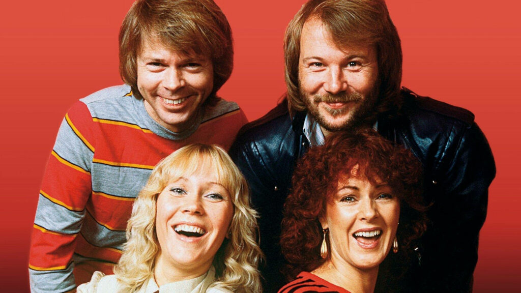 ABBA members reunion wallpaper vibrant red background joyful expressions classic pop music fans