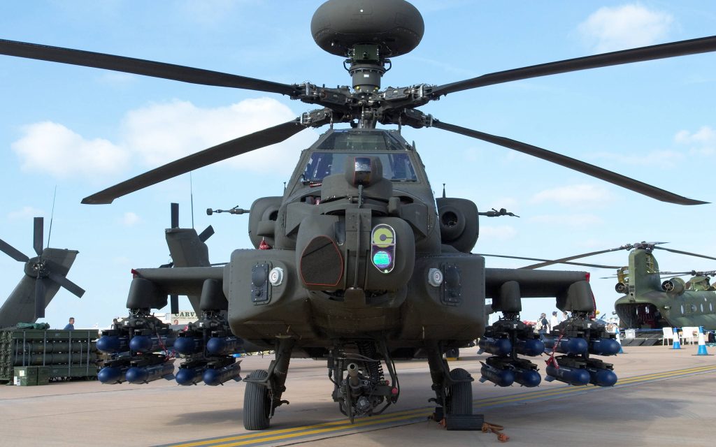 AH-64 Apache Longbow helicopter on sunny airfield with training missiles Chinook in background Wallpaper