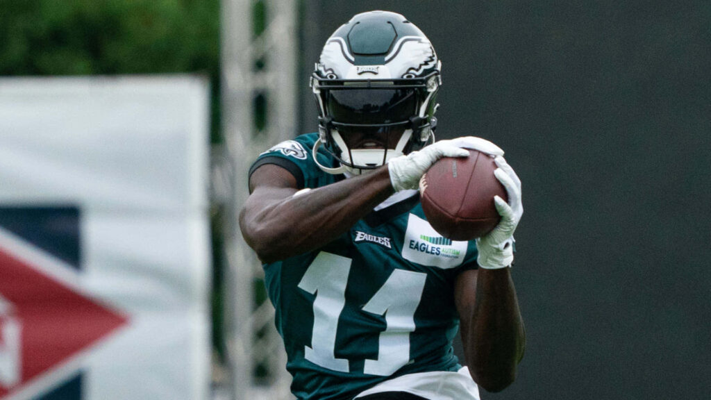 AJ Brown catching football in Philadelphia Eagles uniform during intense practice session Wallpaper
