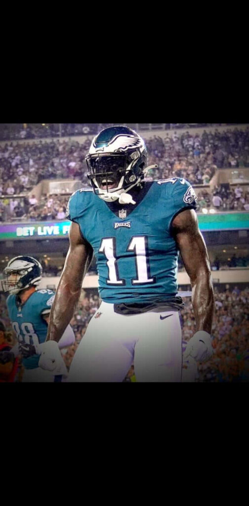 A J Brown Philadelphia Eagles celebrating on field powerful focused football player wallpaper background