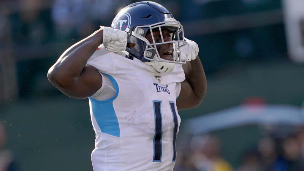 A J Brown celebrating in Tennessee Titans uniform flexing muscles showing athleticism and determination Wallpaper