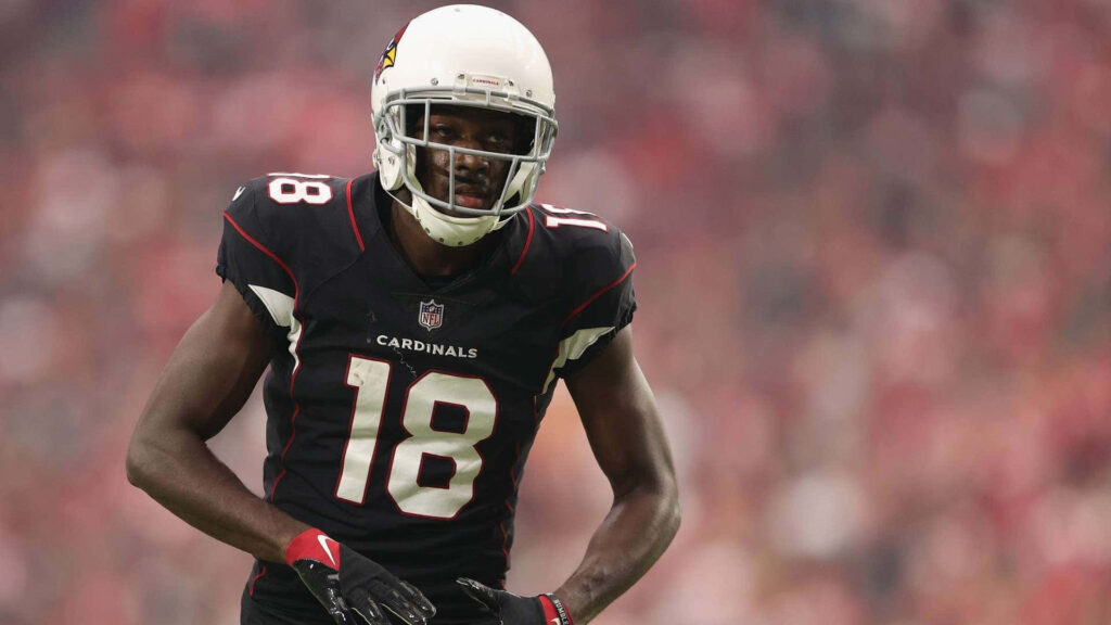 A.J. Green focused in Arizona Cardinals uniform during intense football game action wallpaper
