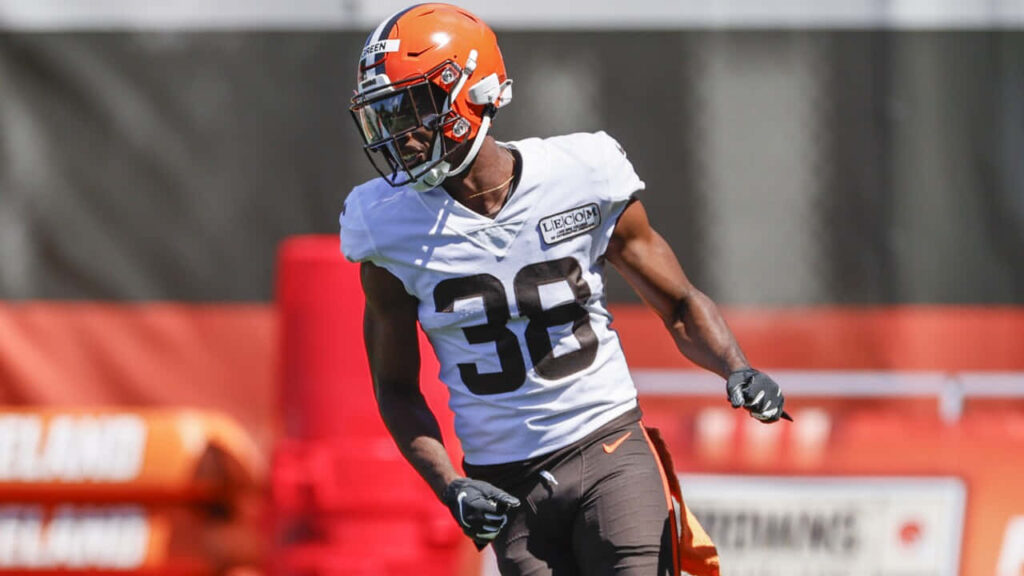 A.J. Green in full football gear training intensely on practice field mid-motion wallpaper background