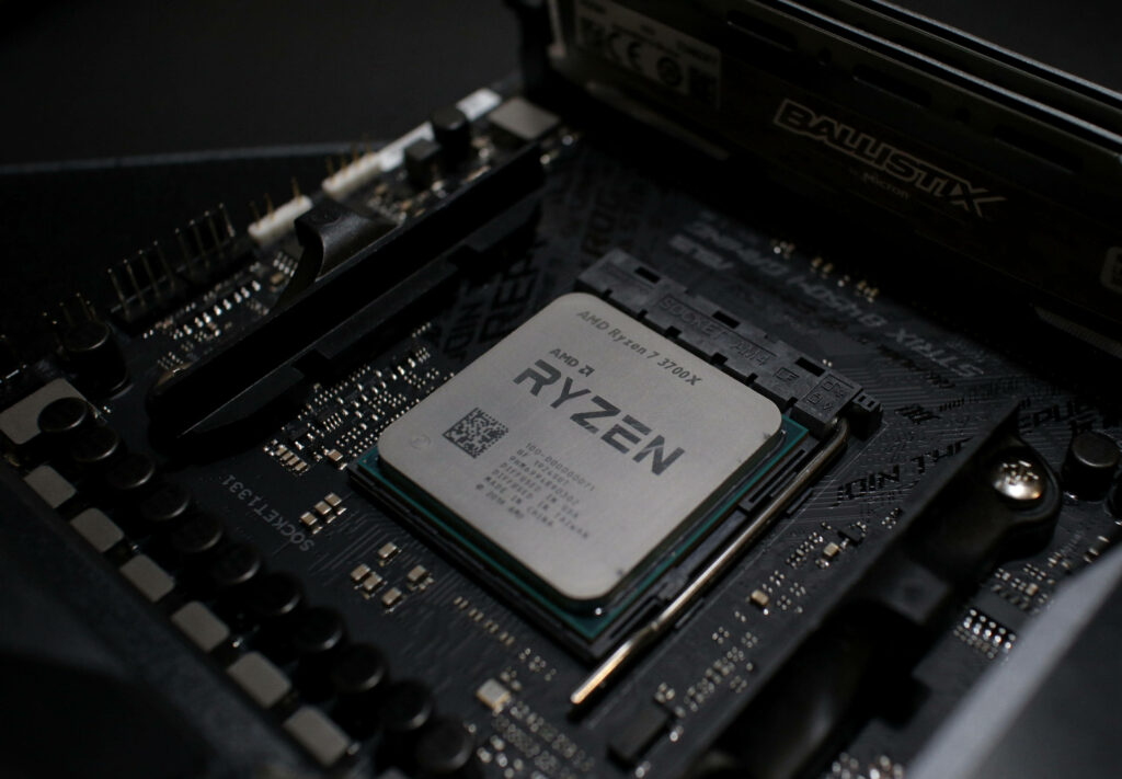 Close-up of AMD Ryzen processor on black motherboard showcasing high-performance computing in 4K Wallpaper