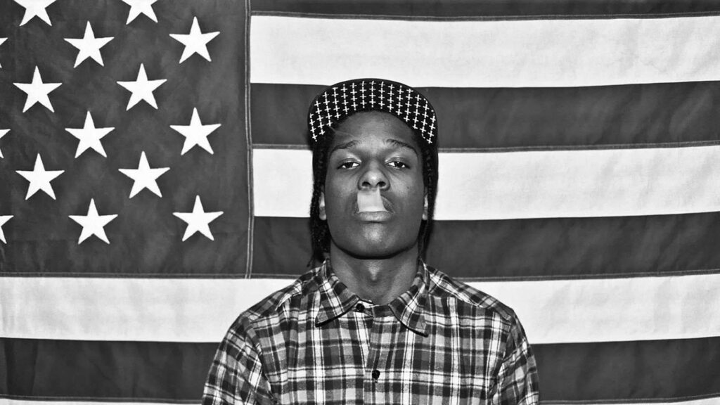 A$AP Rocky confident pose American flag background bold stylish hip hop wallpaper design