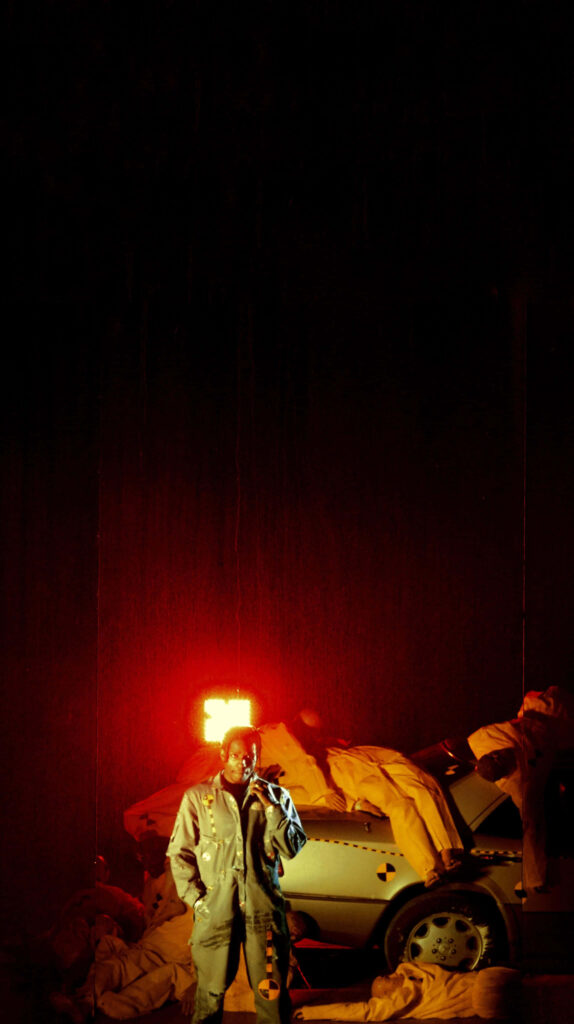 ASAP Rocky near vehicle with bold red lighting embodying edgy Testing era wallpaper background