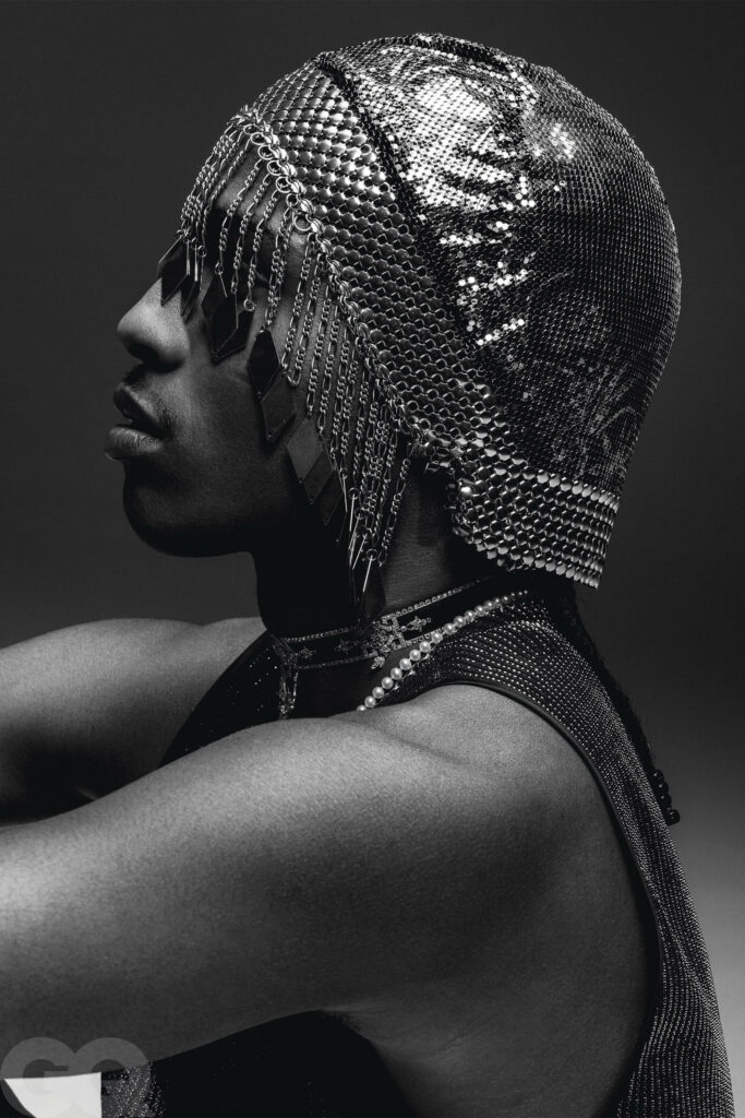 A$AP Rocky in bold vintage flapper cap showcasing unique style on monochrome wallpaper background