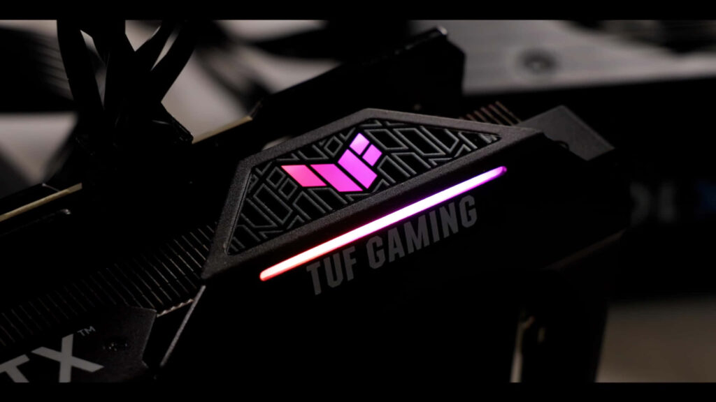 Close up ASUS TUF Gaming graphics card with vibrant RGB lighting and sleek design details wallpaper