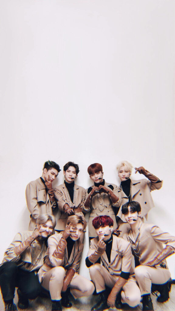 ATEEZ members in coordinated brown outfits posing stylishly on minimalist brown aesthetic wallpaper