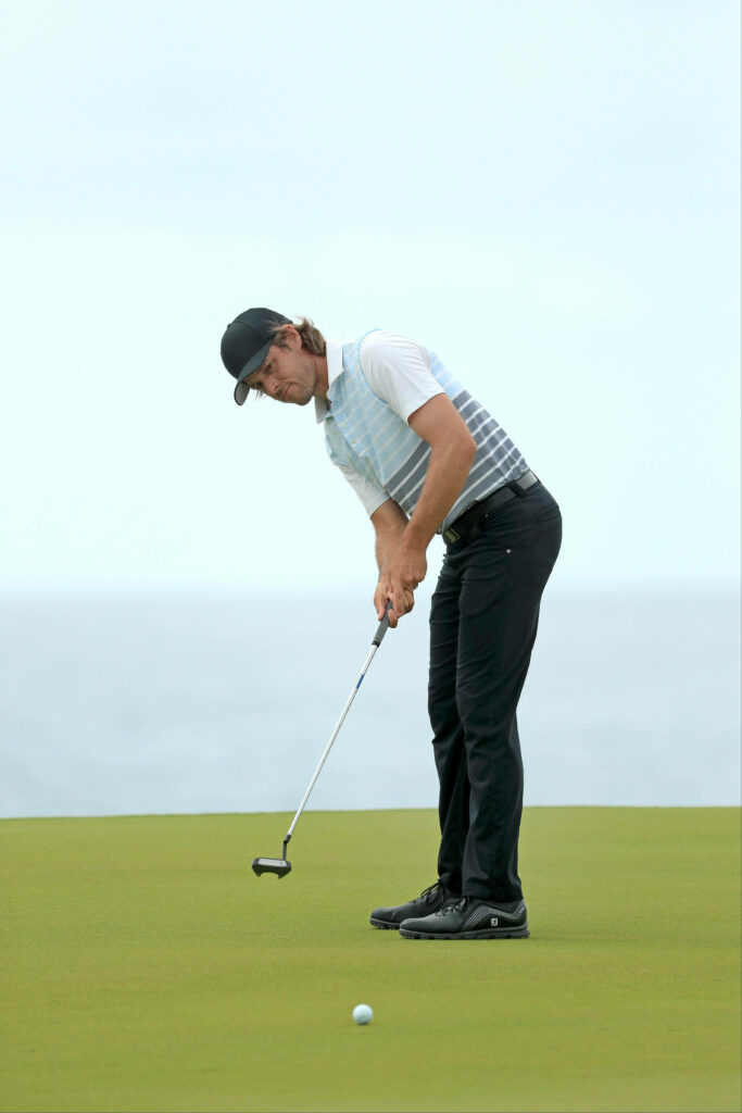 Aaron Baddeley concentrating on a critical putt at Australian Open golf tournament green wallpaper