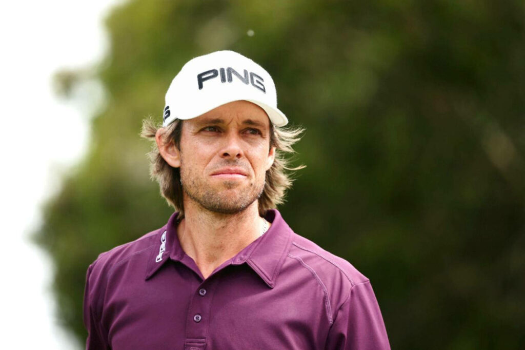 Professional golfer Aaron Baddeley in PING cap maroon shirt focused outdoor golf wallpaper background