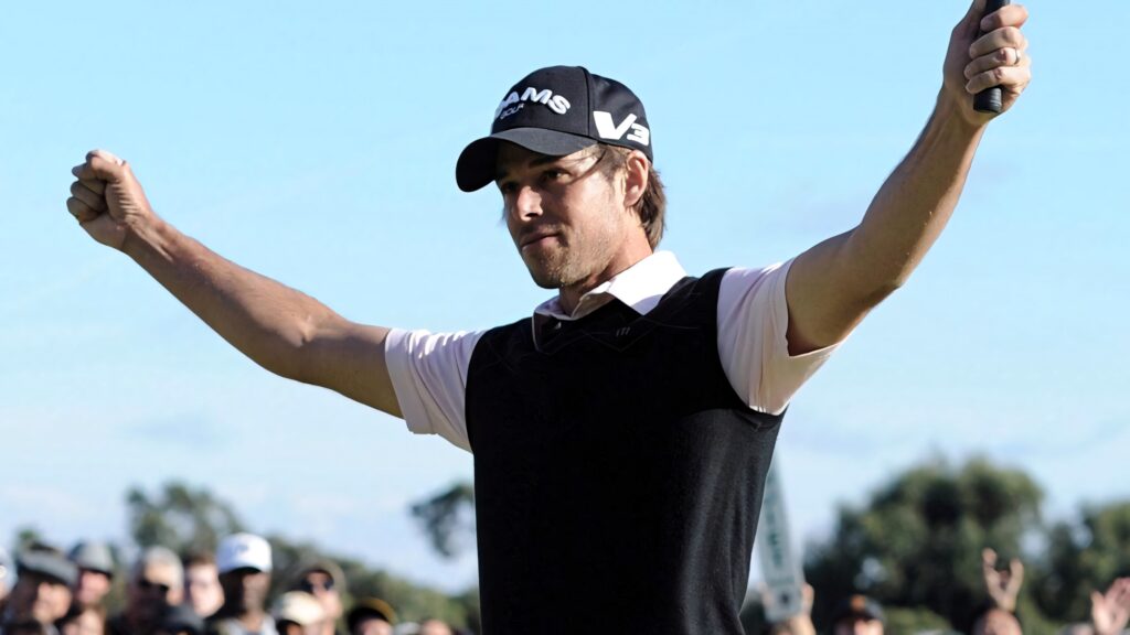Aaron Baddeley celebrates victory at Holden Australian Open raising arms with crowd background Wallpaper