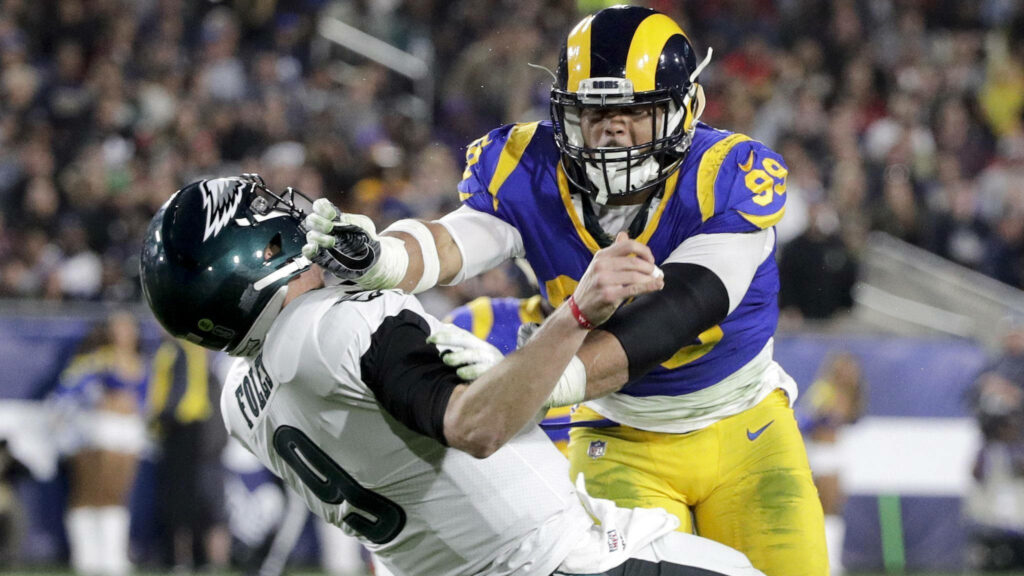 Aaron Donald tackles Nick Foles in intense NFL game action professional football wallpaper background