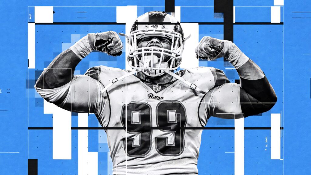 Aaron Donald flexing biceps in white Rams jersey with bold blue geometric background wallpaper