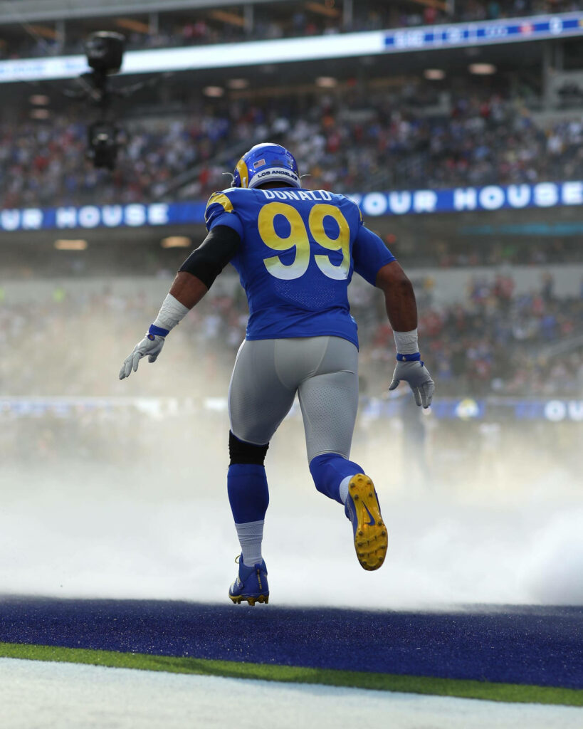 Aaron Donald in Los Angeles Rams uniform charges through smoke for NFL football game wallpaper