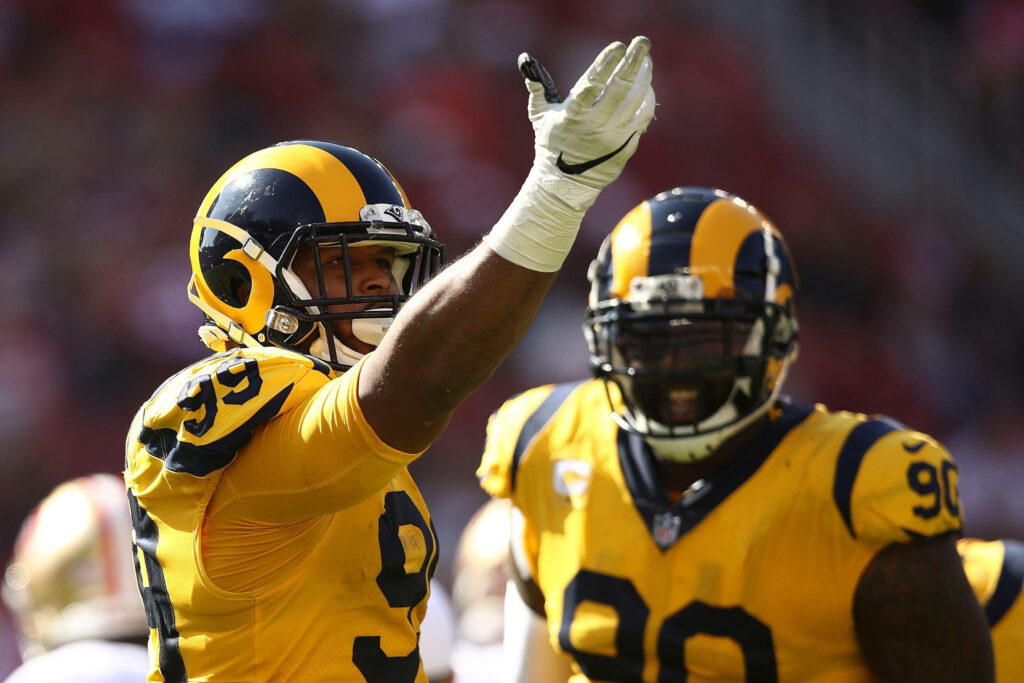 Aaron Donald in vibrant yellow jersey showing intense focus during NFL game action wallpaper