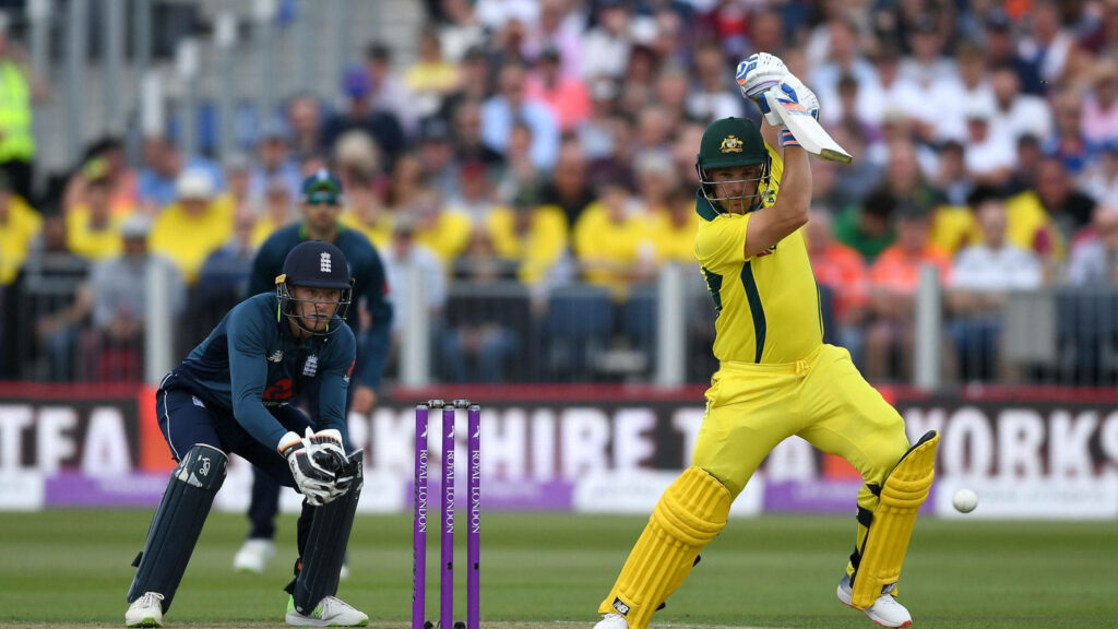 Aaron Finch batting for Australia against England in intense cricket match yellow kit wallpaper
