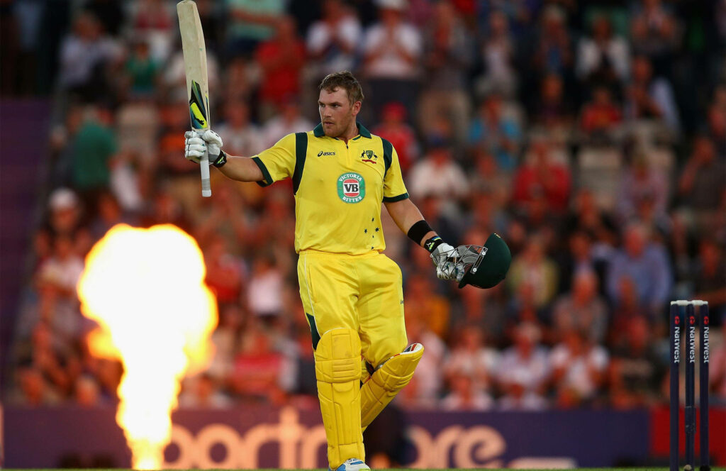 Aaron Finch celebrates cricket milestone raising bat Australian player fiery crowd wallpaper background