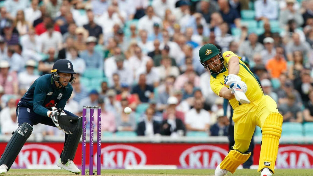 Aaron Finch swinging cricket bat powerfully during intense match showcasing dynamic batting skills Wallpaper