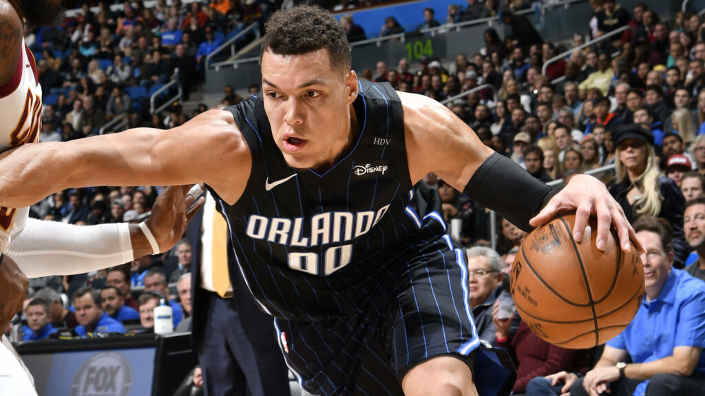 Aaron Gordon driving aggressively to the basket in Orlando Magic jersey during intense game action Wallpaper