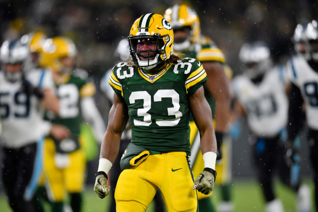 Aaron Jones Green Bay Packers running back shows intensity and energy on NFL football field Wallpaper