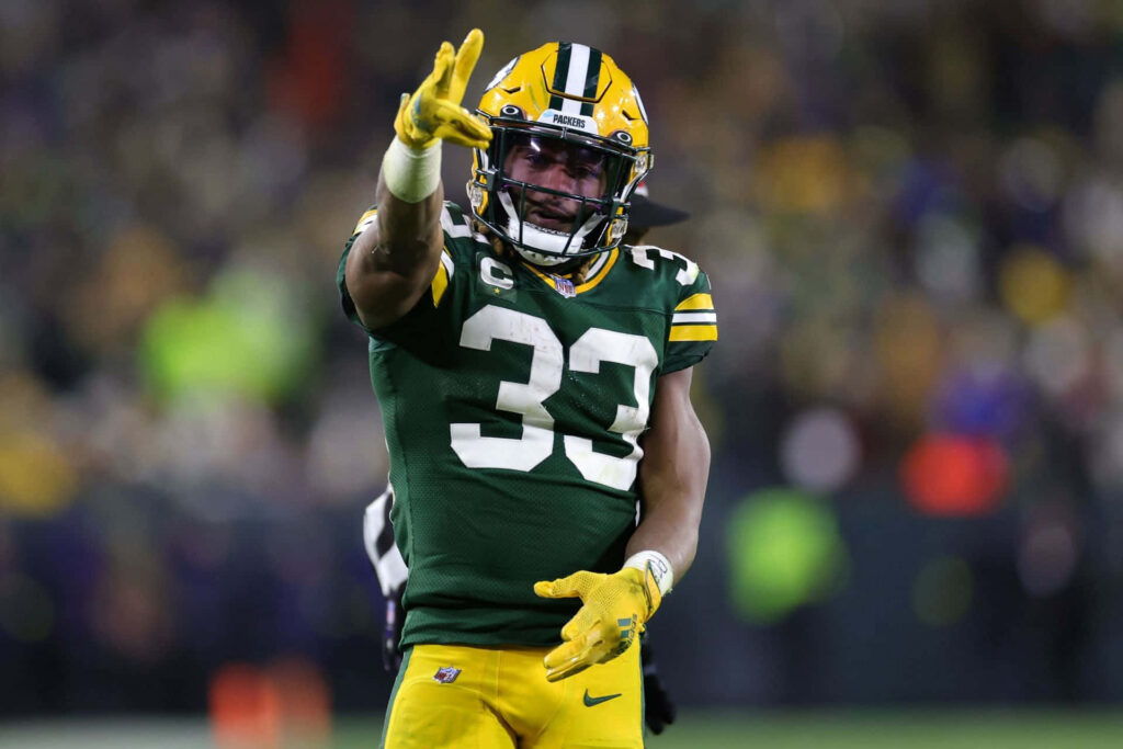Aaron Jones Green Bay Packers sprinting football player intense focus dynamic wallpaper background